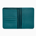 Teal Vegan Leather Passport Holder open to display card slots on the left, a transparent ID section in the center, and a larger pocket on the right, all crafted from vegan leather against a white background.