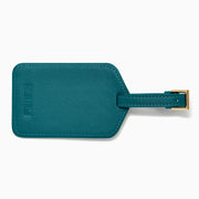A teal Vegan Leather Luggage Tag with a rectangular clear window and an adjustable strap with gold buckle, shown on a white background.