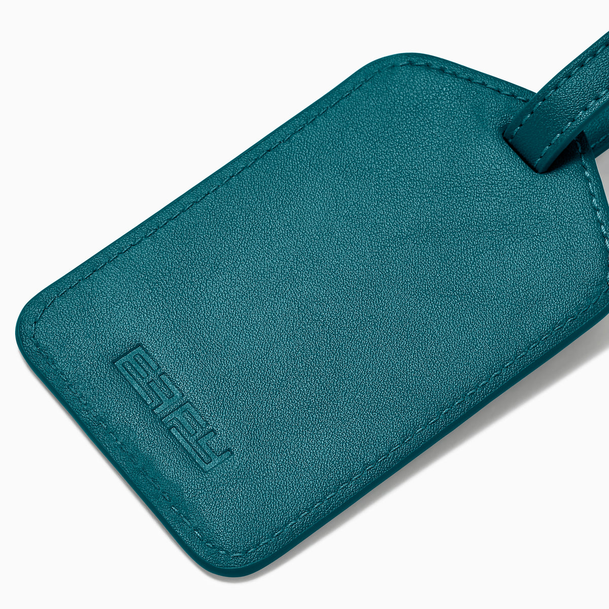 A teal Vegan Leather Luggage Tag with a rectangular clear window and an adjustable strap with gold buckle, shown on a white background.