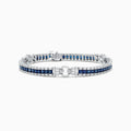 The Royale Bleu 14K White Gold Sapphire and Diamond Bracelet, 7.66 TCW, showcases square blue sapphires bordered by round diamonds and a diamond-encrusted clasp, all displayed on a plain white background.