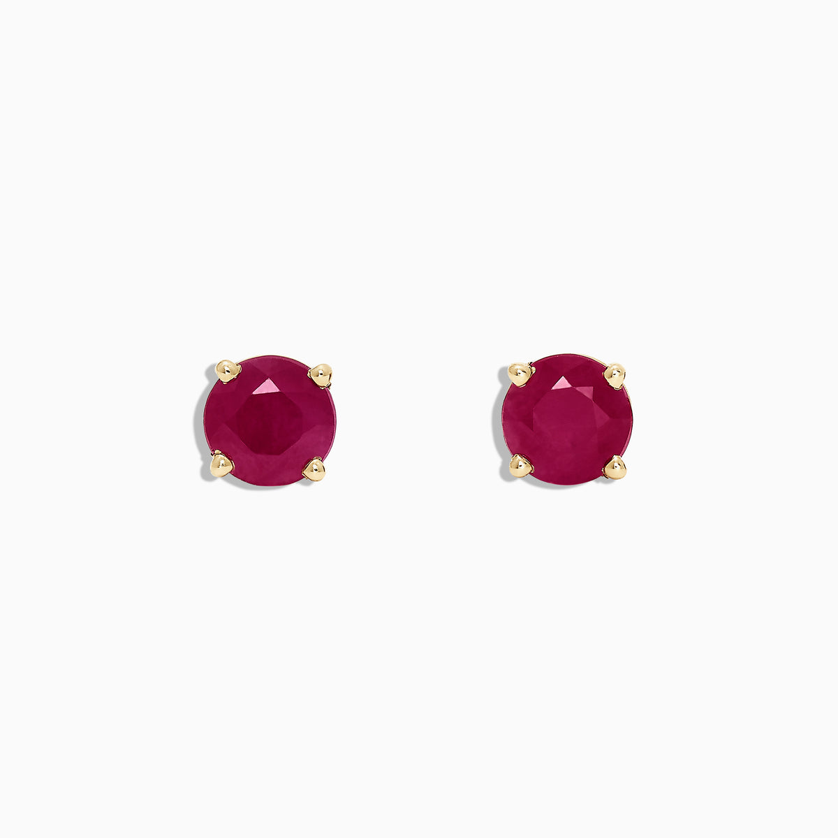 The Ruby Royale 14K Yellow Gold Round Solitaire Ruby Stud Earrings (1.14 TCW) feature faceted rubies in classic four-prong yellow gold settings, showcased on a plain white background.