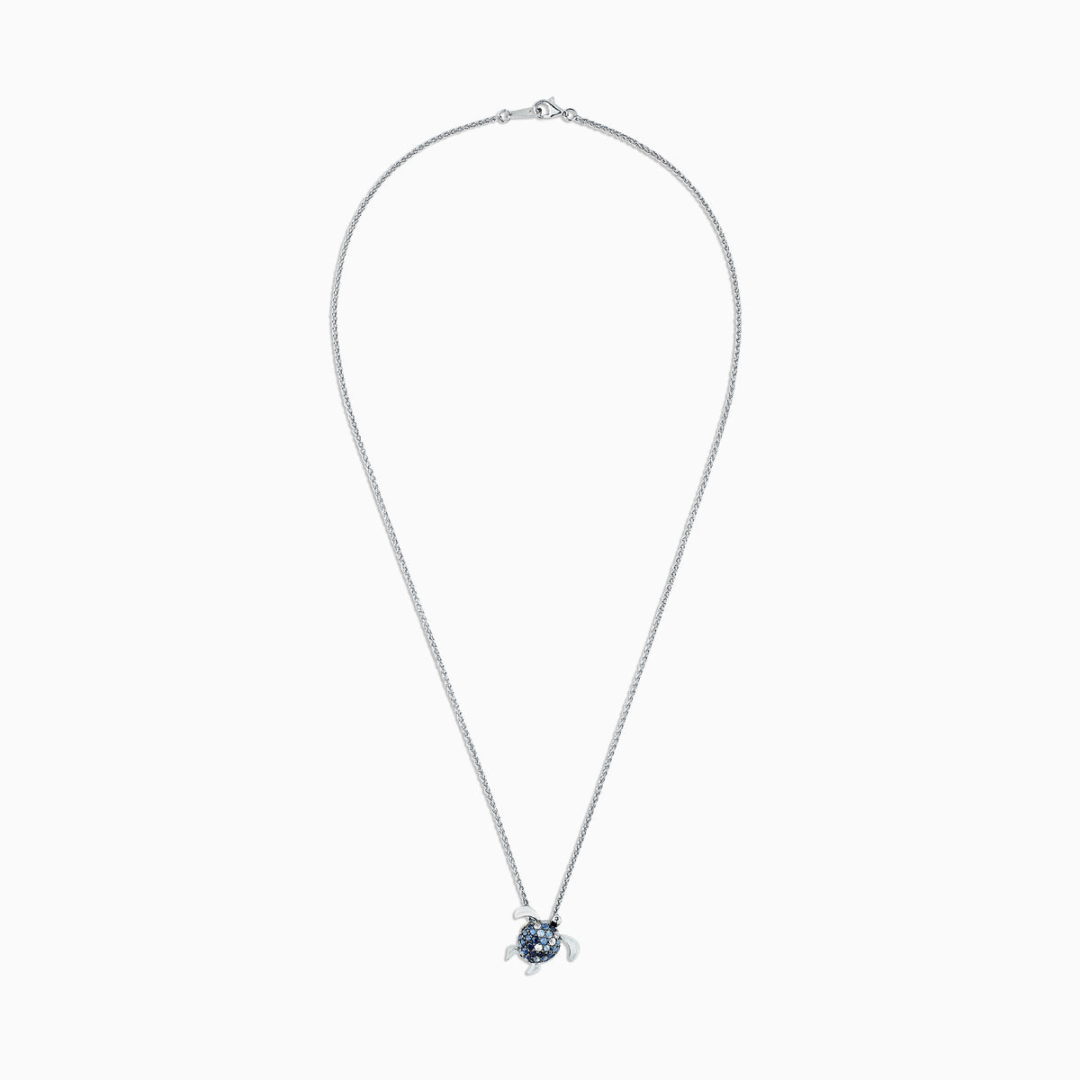 The 925 Sterling Silver Sapphire Splash Turtle Pendant (1.00 TCW) features blue and white gemstones on its shell and is shown against a white background.