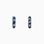 The 925 Sterling Silver Blue Sapphire Splash 1/2 Hoop Earrings, 1.77 TCW, feature alternating rows of blue sapphire and white gemstones and are shown on a plain white background.