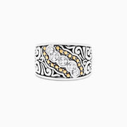 The 925 Sterling Silver and 18K Yellow Gold Diamond Ring, 0.10 TCW features a wide band with black swirls, a central row of sparkling diamonds, and small 18K yellow gold accents.