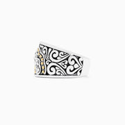 The 925 Sterling Silver and 18K Yellow Gold Diamond Ring, 0.10 TCW features a wide band with black swirls, a central row of sparkling diamonds, and small 18K yellow gold accents.