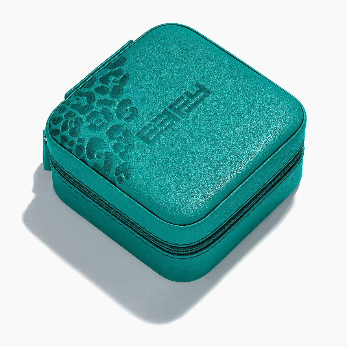 The Faux Leather Jewelry Travel Case is a square teal case with a textured leopard print accent on one corner and EFFY embossed on the lid. It features a zipper closure and is shown on a light background with a soft shadow.