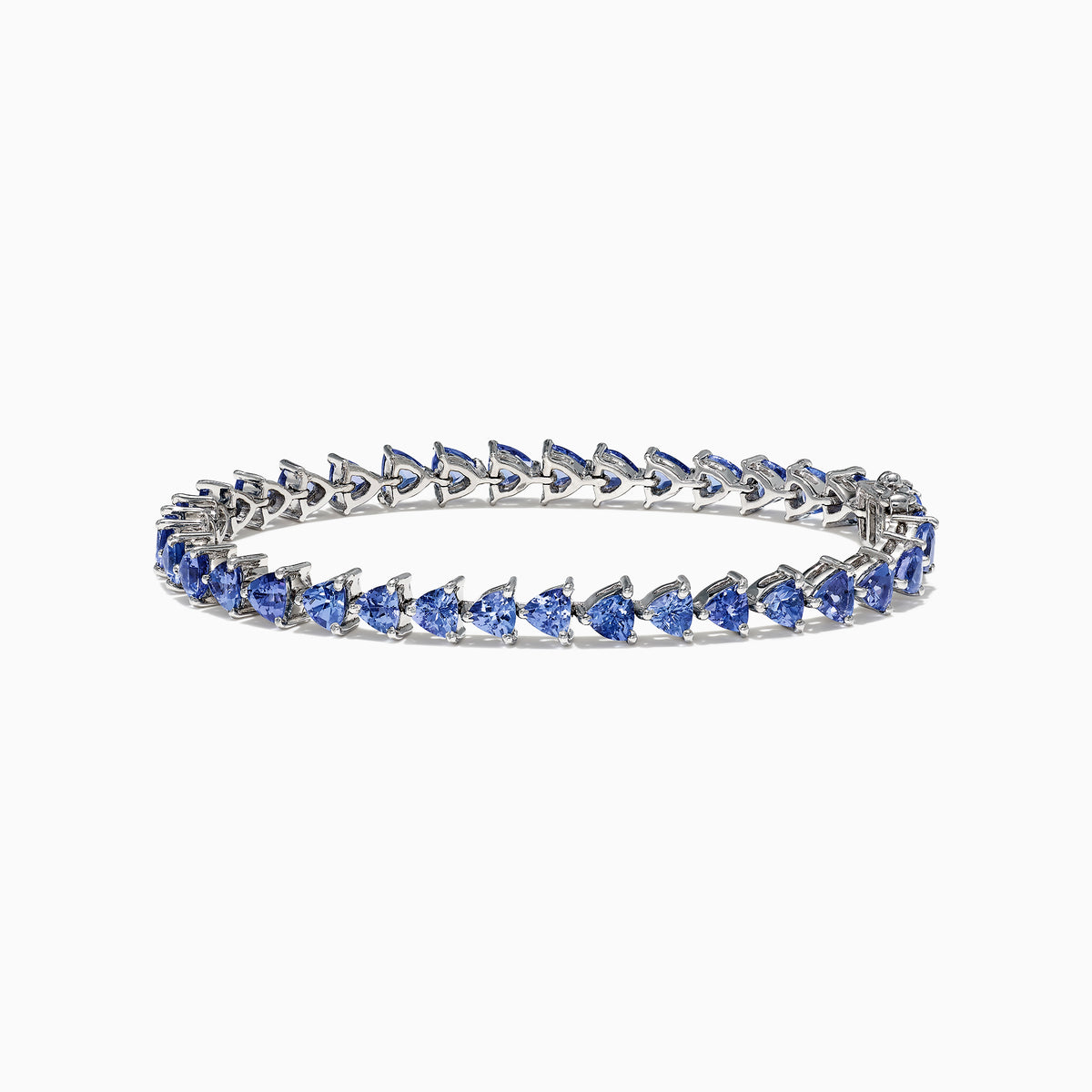The Nahla Siri Sterling Silver Tanzanite Bracelet, 7.45 TCW, showcases blue triangular gemstones set in prongs and evenly spaced around the band, beautifully displayed against a white background.