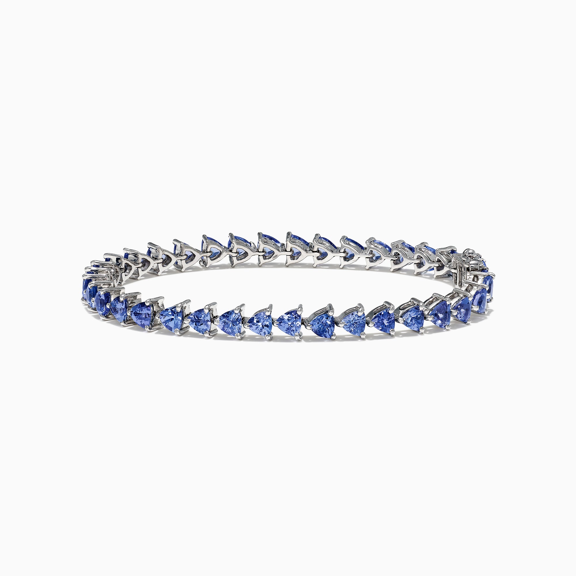 The Nahla Siri Sterling Silver Tanzanite Bracelet, 7.45 TCW, showcases blue triangular gemstones set in prongs and evenly spaced around the band, beautifully displayed against a white background.