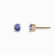 A pair of 14K Yellow Gold Oval Tanzanite Stud Earrings, 0.65 TCW, is shown on a white background.