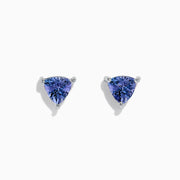 The 14K White Gold Trillion Cut Tanzanite Stud Earrings, 0.65 TCW, feature trillion-cut tanzanite gemstones in three-prong settings displayed against a white background.