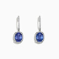Elegant 14K white gold earrings featuring oval tanzanite gemstones and sparkling diamonds, totaling 4.14 TCW, with additional diamonds along the hooks.