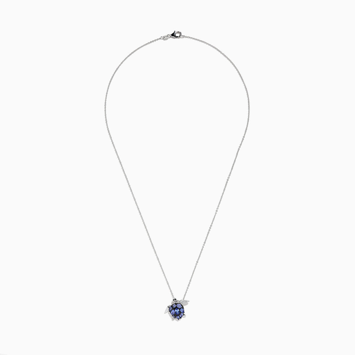 The Seaside 925 Sterling Silver Multi Diamond and Tanzanite Turtle Pendant features a turtle-shaped design with tanzanite gemstones on its shell and clear stones on one flipper, shown against a white background.