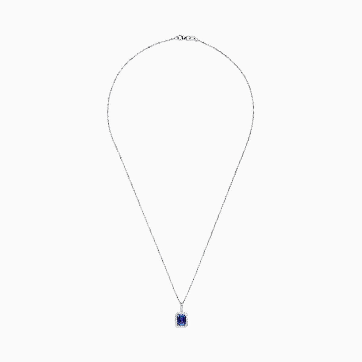 The Nahla Siri 14K White Gold Tanzanite and Diamond Pendant, 1.56 TCW, features a rectangular tanzanite surrounded by sparkling diamonds, elegantly displayed against a white background.