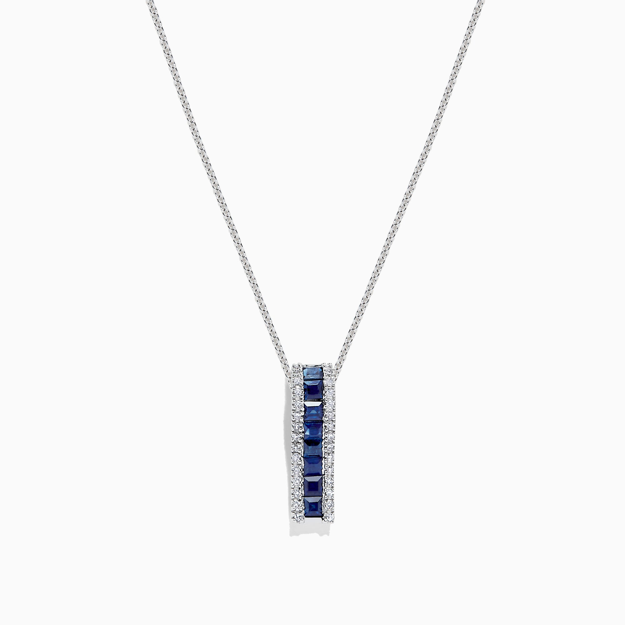 The 14K White Gold Blue Sapphire and Diamond Pendant (1.20 TCW) features a vertical design with square-cut blue sapphires at the center, bordered by sparkling diamonds.
