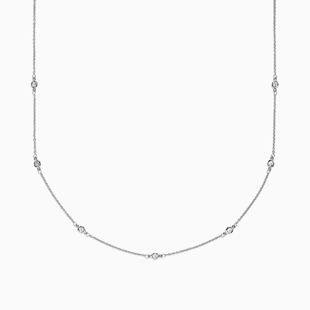 The 14K White Gold 18 Diamond Station Necklace, 0.21 TCW, features small diamonds spaced along a fine chain and is displayed against a plain white background.