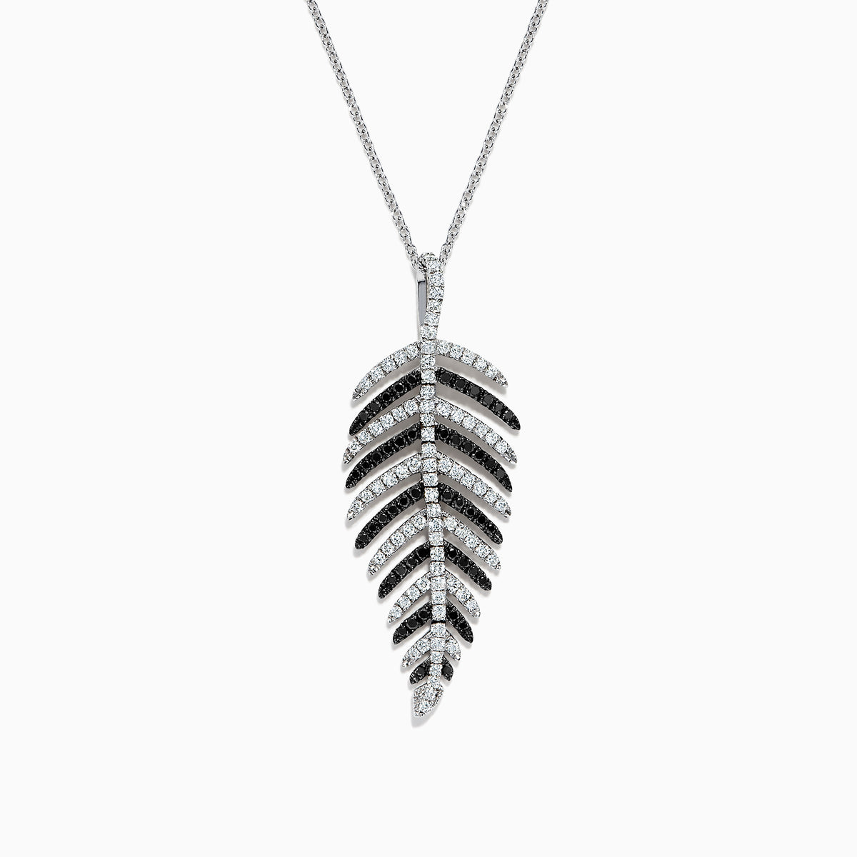 A 14K white gold pendant with .89 TCW black and white diamonds, arranged along leaf-shaped veins, hangs from a thin chain—reminiscent of Effy’s style—shown against a white background.