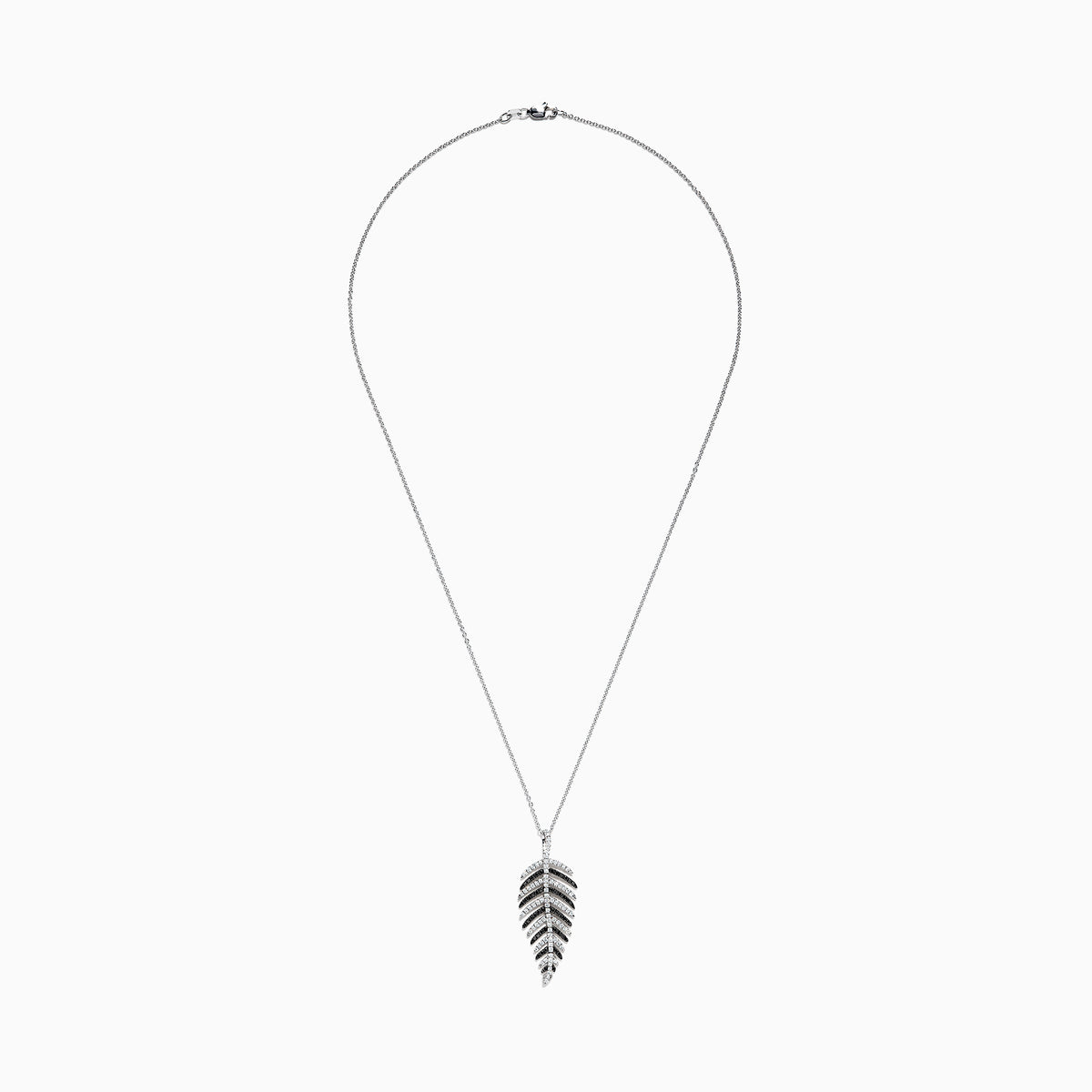 A 14K white gold pendant with .89 TCW black and white diamonds, arranged along leaf-shaped veins, hangs from a thin chain—reminiscent of Effy’s style—shown against a white background.