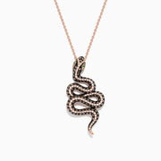 The Safari 14K Rose Gold Diamond and Tsavorite Snake Pendant (1.41 TCW) features a coiled serpent design with diamond and tsavorite eyes, black and white gems along its body, all on a delicate chain.