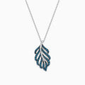 The Bella Bleu 14K White Gold Blue and White Diamond Pendant (0.86 TCW) features a stylized leaf design with alternating blue and white diamonds, suspended from a delicate white gold chain.
