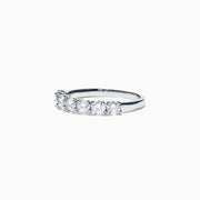 The Pave Classica 14K White Gold Diamond Band 1.03 TCW showcases seven round diamonds in a sleek, minimalist white gold band, elegantly presented against a plain white background.
