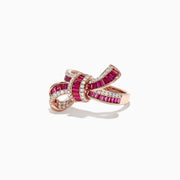 The Ruby Royale 14K Rose Gold Ruby and Diamond Bow Ring (1.61 TCW) showcases interwoven bands of rubies and white diamonds in a bow design, set against a white background.