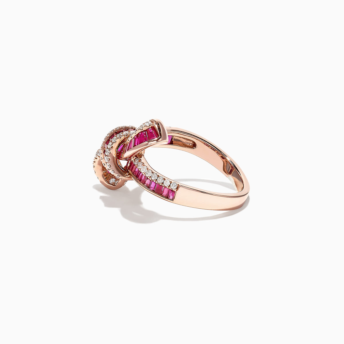 The Ruby Royale 14K Rose Gold Ruby and Diamond Bow Ring (1.61 TCW) showcases interwoven bands of rubies and white diamonds in a bow design, set against a white background.