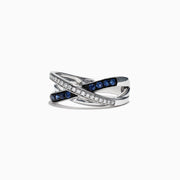 The Royale Bleu 14K White Gold Blue Sapphire and Diamond Ring, 0.39 TCW, showcases an elegant crisscross design with a row of sparkling white diamonds and deep blue sapphires set in overlapping bands.