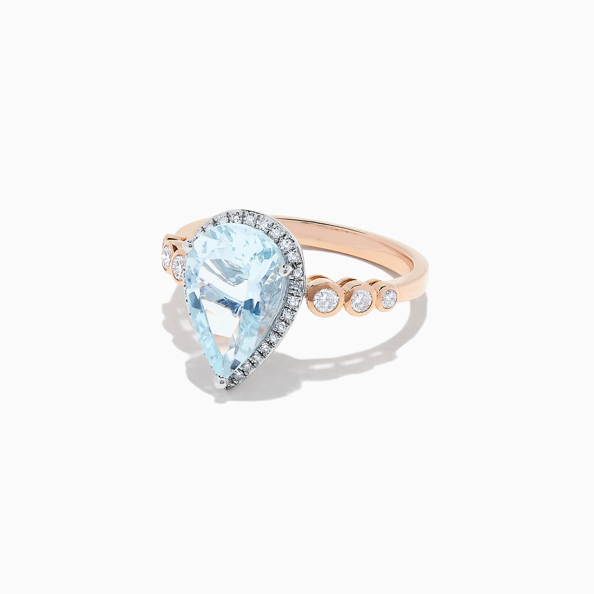 The Aquarius 14K Rose & White Gold Aquamarine and Diamond Ring, 2.76 TCW, showcases a large pear-shaped aquamarine accented by diamonds on the halo and band, elegantly displayed against a white background.