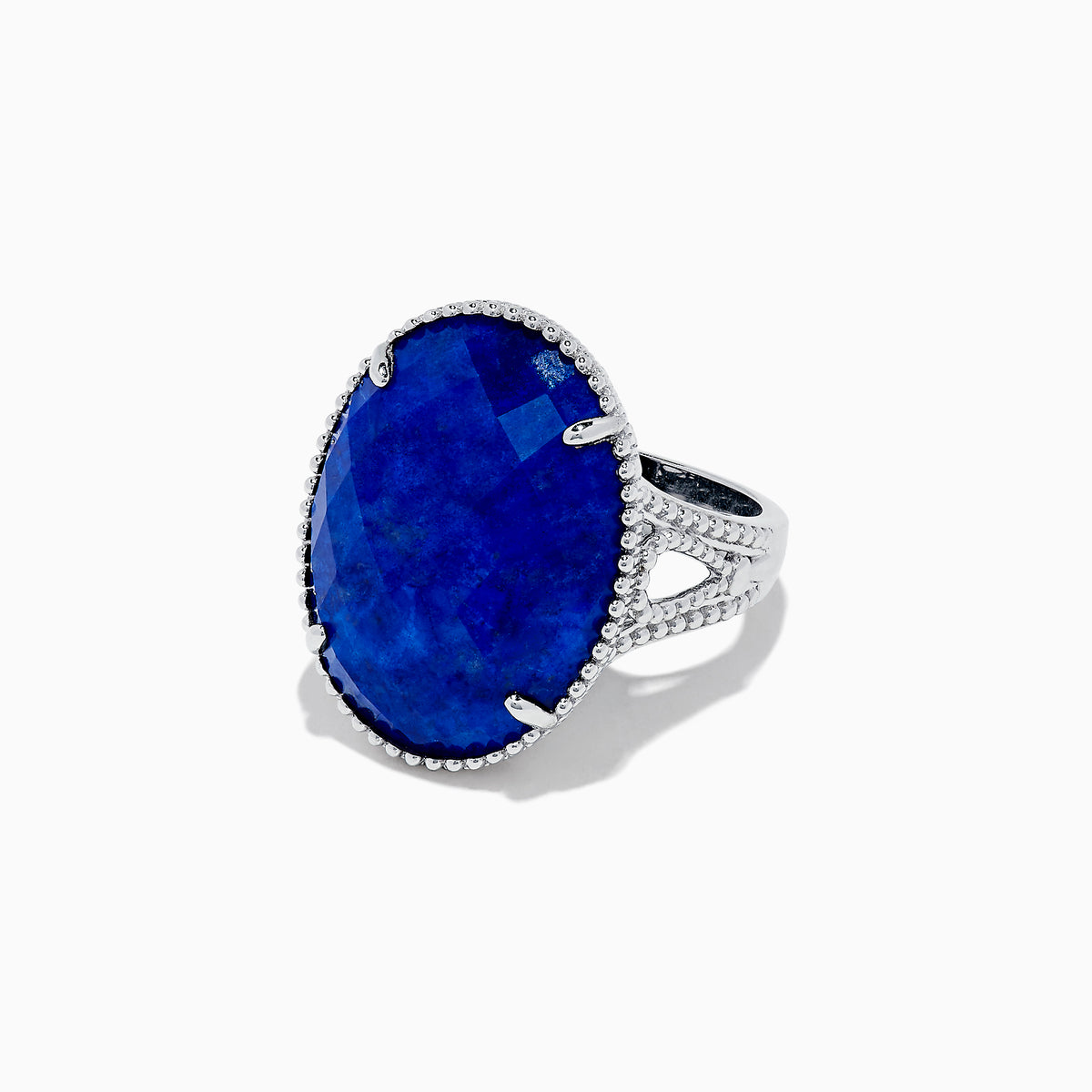 The 925 Sterling Silver Lapis Lazuli Cocktail Ring, 13.85 TCW, features a large faceted oval lapis lazuli gemstone in an ornate prong setting, showcased against a white background.
