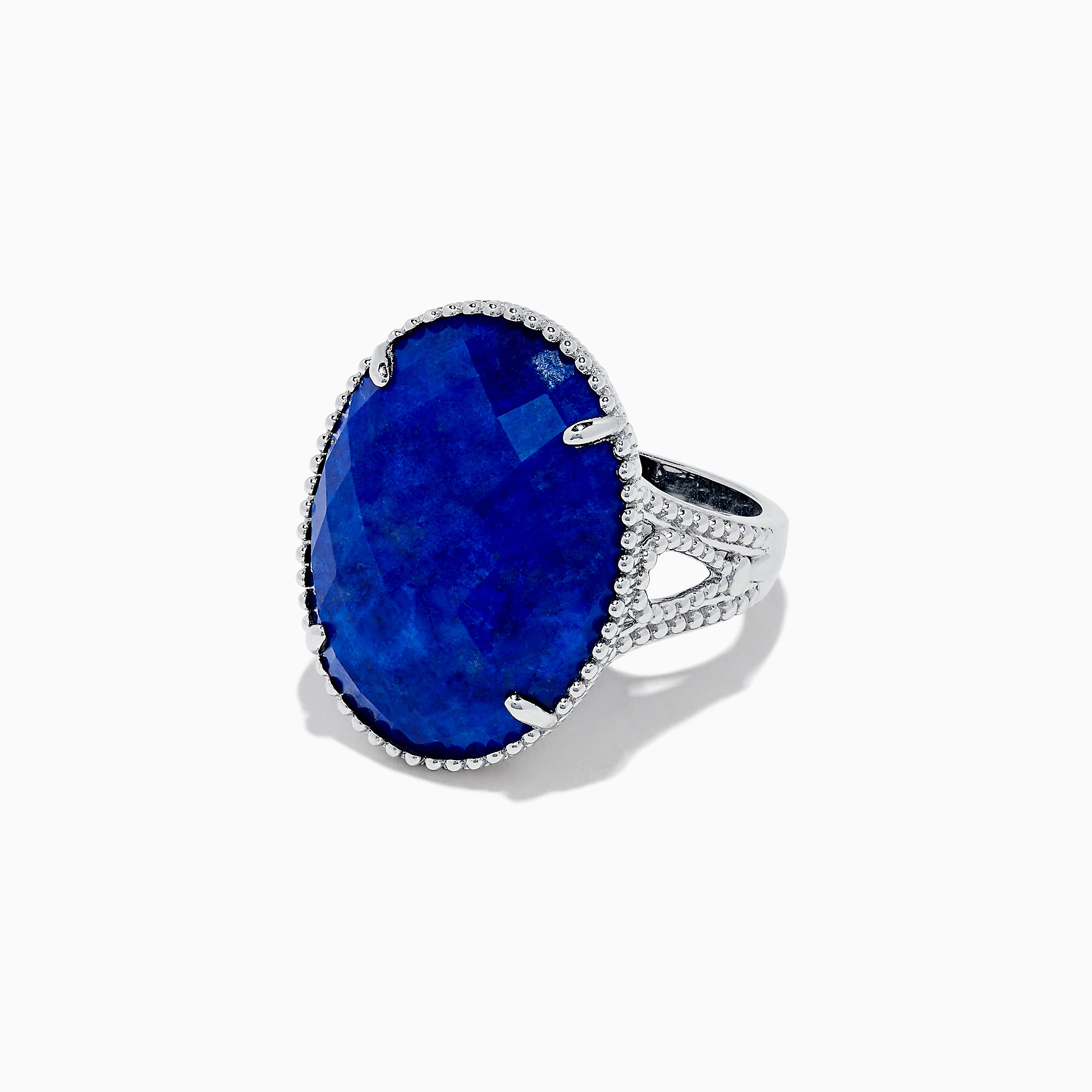 The 925 Sterling Silver Lapis Lazuli Cocktail Ring, 13.85 TCW, features a large faceted oval lapis lazuli gemstone in an ornate prong setting, showcased against a white background.