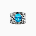 The 925 Lagoon Sterling Silver Blue Topaz Ring, 5.70 TCW features a wide band with a textured wavy design and a large oval blue topaz centerpiece—an elegant statement piece.