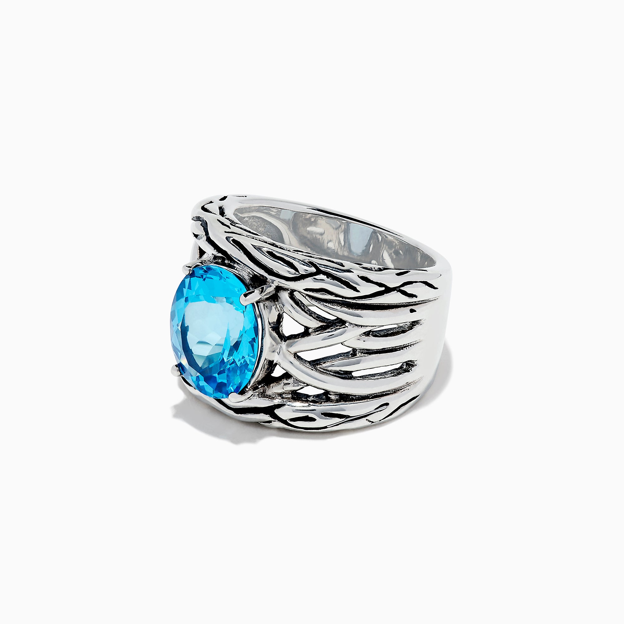 The 925 Lagoon Sterling Silver Blue Topaz Ring, 5.70 TCW features a wide band with a textured wavy design and a large oval blue topaz centerpiece—an elegant statement piece.