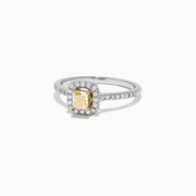 The Canare 18K Two-Tone Gold Cushion Halo Yellow Diamond Ring features a 0.61 TCW square yellow diamond center, surrounded by a halo of clear diamonds and additional diamonds on the band.