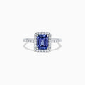 The Nahla Siri 14K White Gold Tanzanite and Diamond Ring, 1.60 TCW, showcases an emerald-cut tanzanite center framed by a halo of diamonds and additional diamonds along the band.