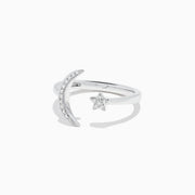The Novelty 14K White Gold Moon and Star Diamond Ring, 0.08 TCW, features a crescent moon with diamonds on one side and a diamond-studded star on the other, beautifully set in white gold.