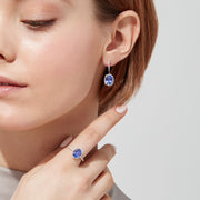 Elegant 14K white gold earrings featuring oval tanzanite gemstones and sparkling diamonds, totaling 4.14 TCW, with additional diamonds along the hooks.