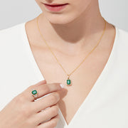 The Brasilica 14K Yellow Gold Emerald & Diamond Pendant, 1.62 TWC, features a rectangular emerald framed by sparkling diamonds on a gold chain, shown against a white background.