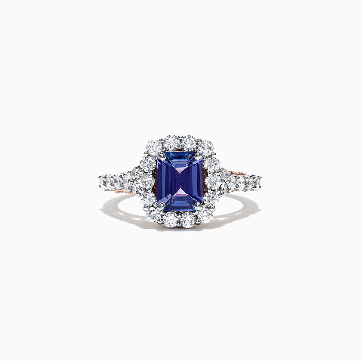 The Nahla Siri 14K Two Tone Gold Emerald Cut Tanzanite and Diamond Ring, 2.32 TCW, showcases a halo of round white diamonds on a diamond-encrusted band, set against a white background.