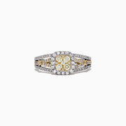 The Canare 14K Two-Tone Gold Cushion Shaped Cluster Yellow Diamond Ring showcases a yellow diamond center with a halo of white diamonds and a split shank band, creating a dazzling cluster effect.
