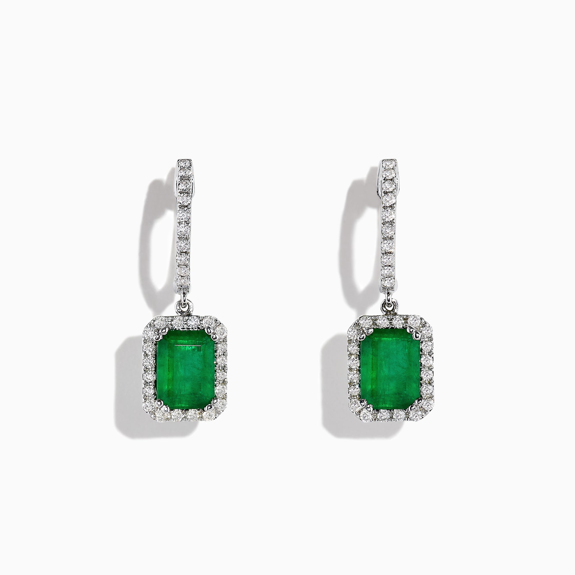 The 14K White Gold Emerald and Diamond Drop Earrings, 2.30 TCW, feature emerald-cut green emeralds surrounded by diamonds and suspended from diamond-studded drops, shown on a white background.