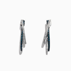 The Bella Bleu 14K White Gold Blue and White Diamond Earrings, 0.58 TCW, feature two intertwined hoops—one adorned with blue and white diamonds—and are displayed against a white background.