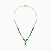 The Brasilica 14K Yellow Gold Emerald and Diamond Necklace, 9.74 TCW, features oval emeralds accented with diamonds and a central teardrop-shaped emerald pendant surrounded by a sparkling diamond halo.