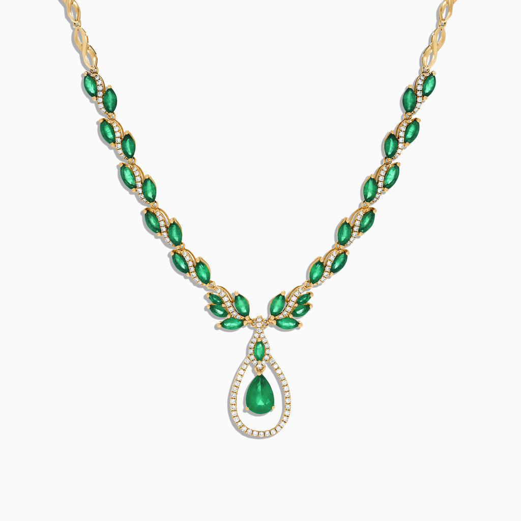 The Brasilica 14K Yellow Gold Emerald and Diamond Necklace, 9.74 TCW, features oval emeralds accented with diamonds and a central teardrop-shaped emerald pendant surrounded by a sparkling diamond halo.