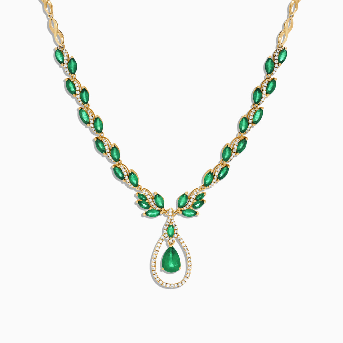 The Brasilica 14K Yellow Gold Emerald and Diamond Necklace, 9.74 TCW, features oval emeralds accented with diamonds and a central teardrop-shaped emerald pendant surrounded by a sparkling diamond halo.