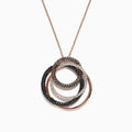 The 14K Rose Gold Espresso, Black & White Diamond Pendant (1.65 TCW) features three interlocking rings set with black and white diamonds, suspended from a delicate chain against a white backdrop.