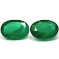 Two Oval Green Emerald 1.50ct gemstones with faceted cuts are displayed side by side on a white background.