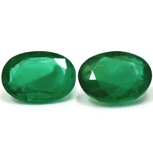 Two Oval Green Emerald 1.50ct gemstones with faceted cuts are displayed side by side on a white background.