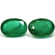 Two Oval Green Emerald 1.50ct gemstones with faceted cuts are displayed side by side on a white background.