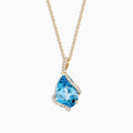 The Ocean Bleu 14K Yellow Gold Pendant features a 6.09 TCW blue topaz framed by sparkling diamonds in an asymmetrical design on a yellow gold chain, set against a white background.