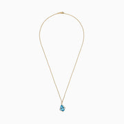 The Ocean Bleu 14K Yellow Gold Pendant features a 6.09 TCW blue topaz framed by sparkling diamonds in an asymmetrical design on a yellow gold chain, set against a white background.